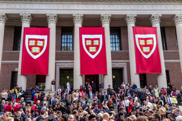 Harvard graduation ceremony with banners and crowd outside