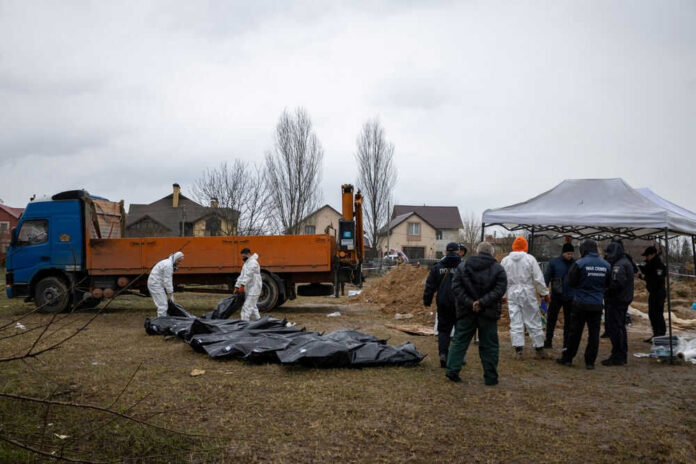 People in protective gear with a blue truck
