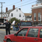 Police officer directing traffic near ambulance scene