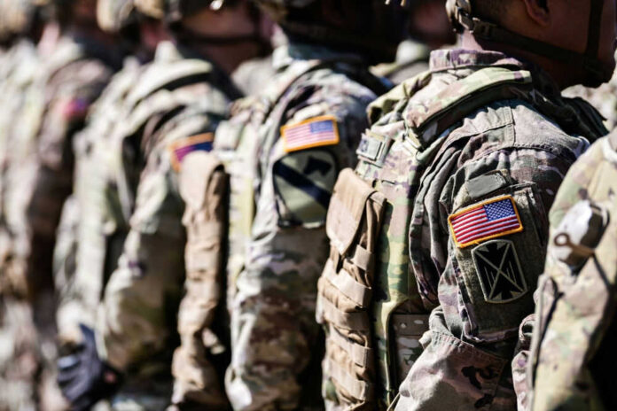 2321207565 Military personnel in camouflage uniforms standing in line