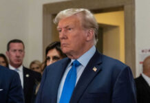Unprecedented Power Grab Shakes Trump Trial Man in blue suit with serious expression indoors