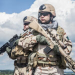 Embassy Firefight Erupts – U.S. Marines Clash With Gangs Two soldiers in desert camouflage holding rifles