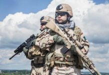 Embassy Firefight Erupts – U.S. Marines Clash With Gangs Two soldiers in desert camouflage holding rifles