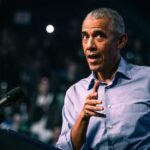 Elite Privilege EXPOSED: Obama Campaign Money Scandal Erupts A speaker gesturing while addressing an audience