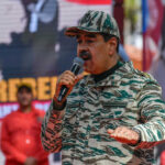$50M Reward: Maduro’s Birthday Bombshell Man in camouflage uniform speaking at event outdoors
