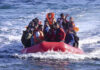 Mediterranean Horror: 42 Migrants Perish A group of people in a red inflatable boat on the ocean