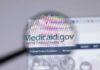 Magnifying glass over Medicaid website homepage