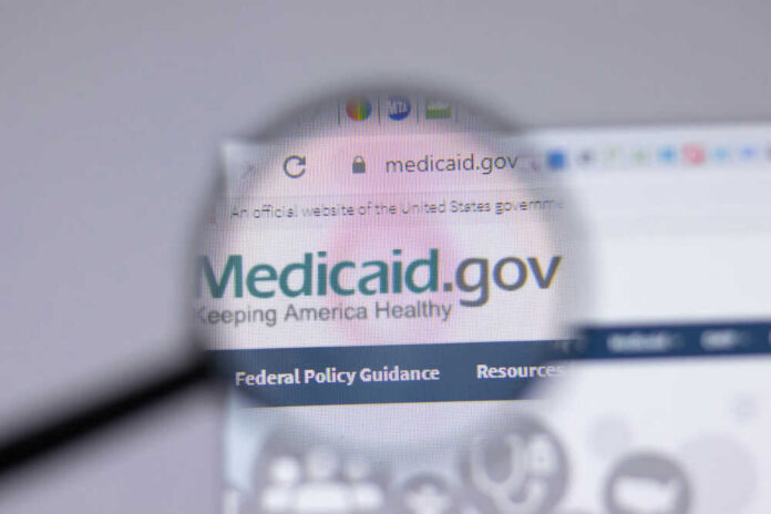 Magnifying glass over Medicaid website homepage