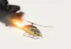 Helicopter on fire with smoke in the sky