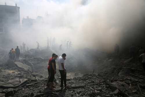 shutterstock_2374212955.jpg People standing amidst smoke and debris after a disaster