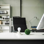Office desk with computer and lightbulb decoration